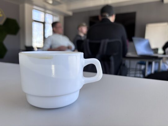 A coffee cup on a table at a meeting