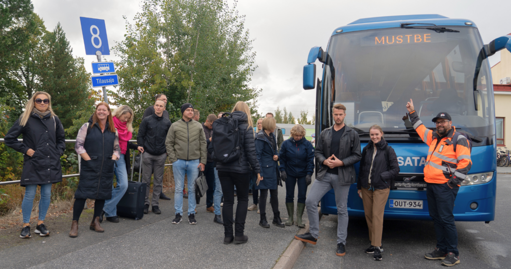 The MUSTBE partners standing in front of a bus.