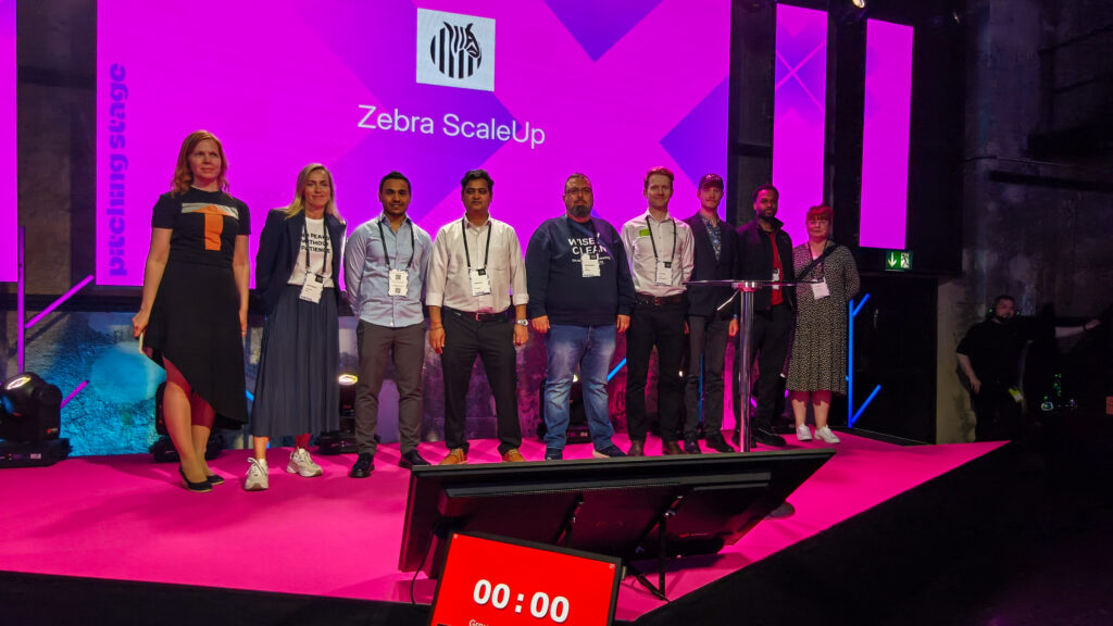 Zebra ScaleUp company representatives and team members on stage at Latitude59 event.