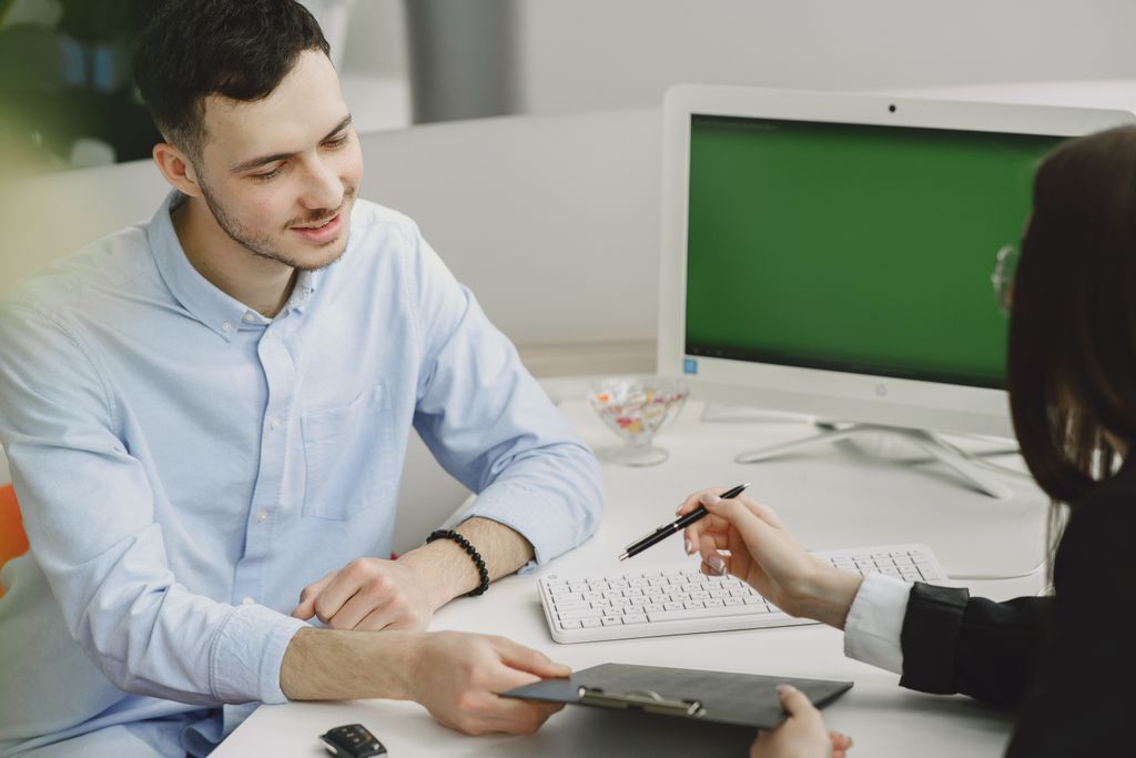 Two people discussing a document at a modern office desk