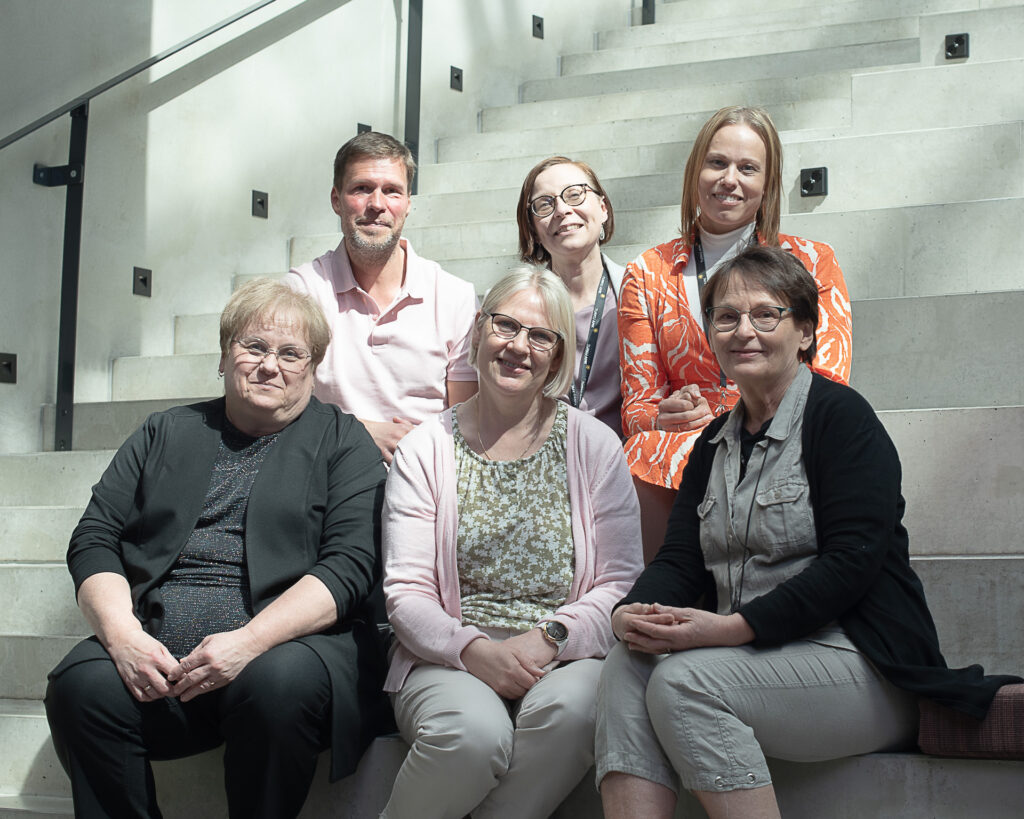 DiMod project team and Central Baltic representative are sitting on stairs for a group picture
